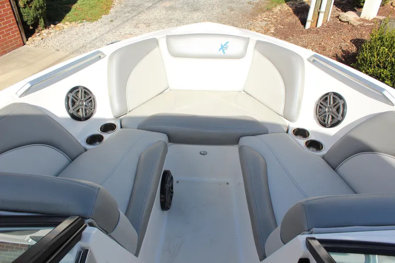 Slide: The Image of 2016 MasterCraft X30 boat interior with gray seating and built-in speakers. - 11