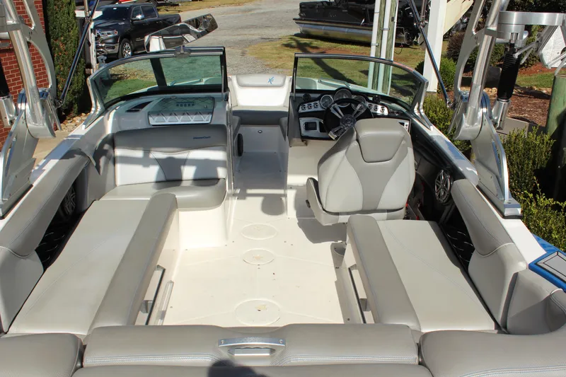 Slide: The Image of 2016 MasterCraft X30 boat interior with gray seating and modern dashboard. - 6