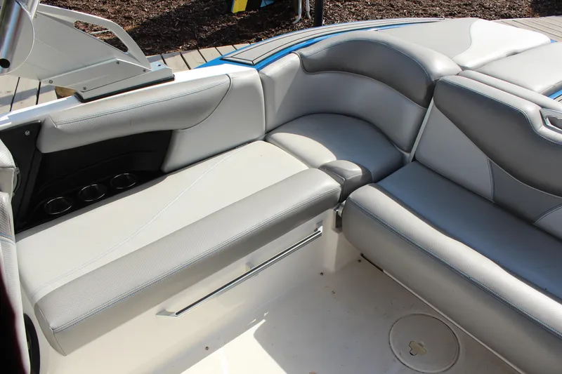 Slide: The Image of 2016 MasterCraft X30 boat interior with gray seating and cup holders. - 7