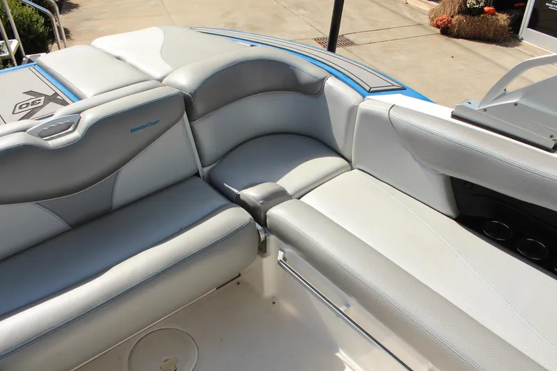 Slide: The Image of 2016 MasterCraft X30 boat interior with gray seating and cup holders. - 8