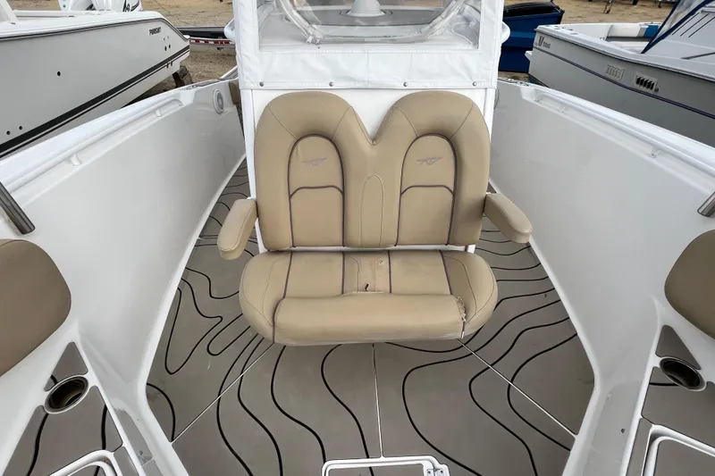 Slide: The Image of 2016 Tidewater 280 CC Adventure boat with beige seating and patterned flooring. - 11