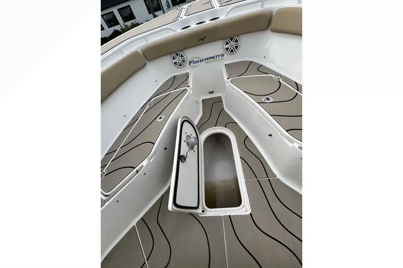 Slide: The Image of 2016 Tidewater 280 CC Adventure boat interior with open storage compartment. - 12