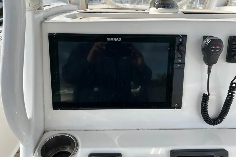 Slide: The Image of Simrad display and radio on 2016 Tidewater 280 CC Adventure boat console. - 21