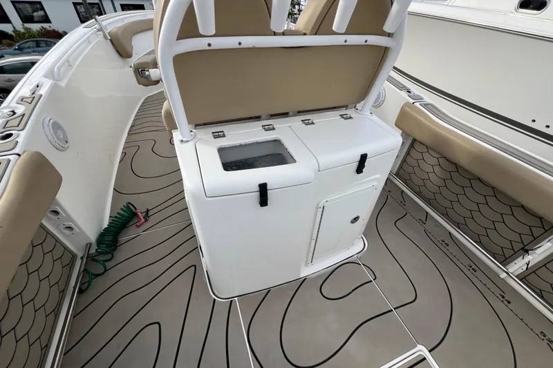 Slide: The Image of 2016 Tidewater 280 CC Adventure boat interior with seating and storage compartments. - 23