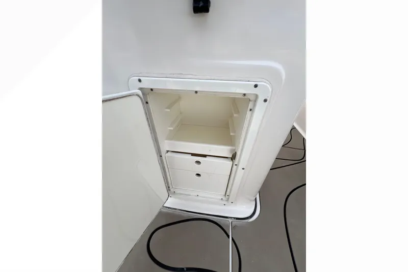 Slide: The Image of Open storage compartment on 2016 Tidewater 280 CC Adventure boat. - 26