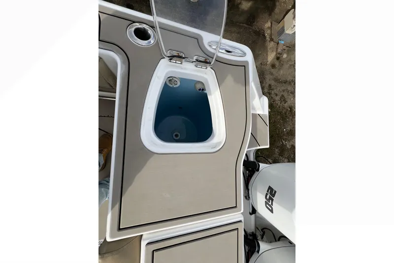 Slide: The Image of 2016 Tidewater 280 CC Adventure boat deck with open storage compartment. - 27