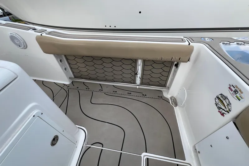 Slide: The Image of 2016 Tidewater 280 CC Adventure boat interior with cushioned seating and non-slip flooring. - 29