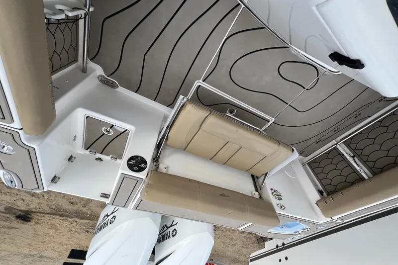 Slide: The Image of 2016 Tidewater 280 CC Adventure boat interior with seating and Yamaha engines. - 31