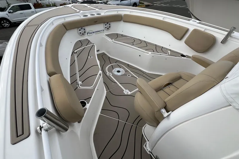 Slide: The Image of 2016 Tidewater 280 CC Adventure boat interior with beige seating and stylish flooring. - 5