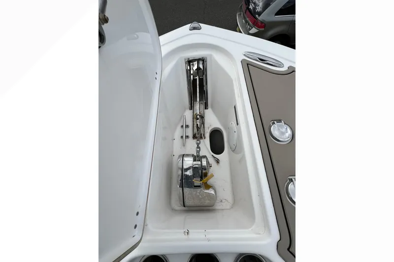 Slide: The Image of Anchor compartment of 2016 Tidewater 280 CC Adventure boat, featuring stainless steel hardware. - 7