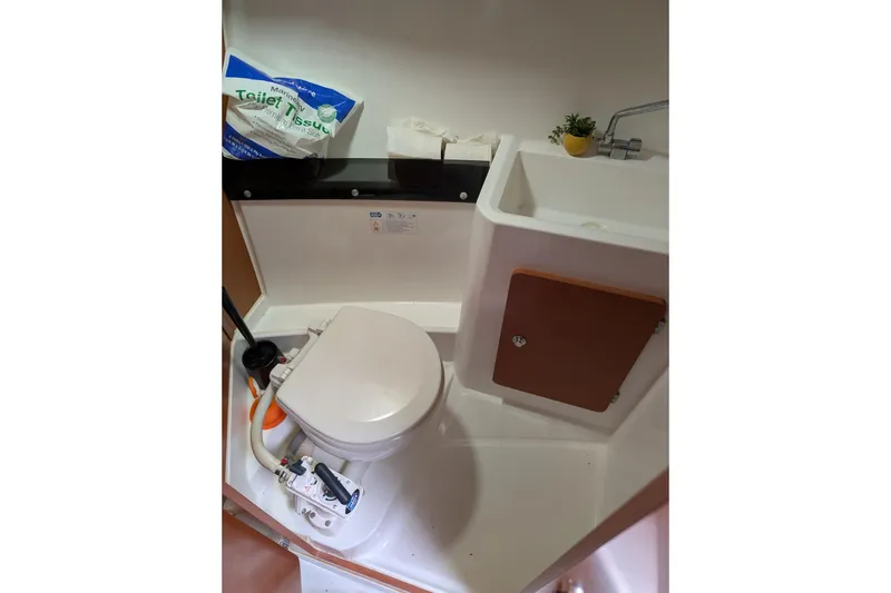 Slide: The Image of 2016 Jeanneau Merry Fisher 795 boat bathroom with toilet and sink. - 12