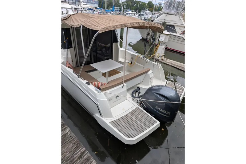 Slide: The Image of 2016 Jeanneau Merry Fisher 795 boat docked with Yamaha outboard motor. - 2