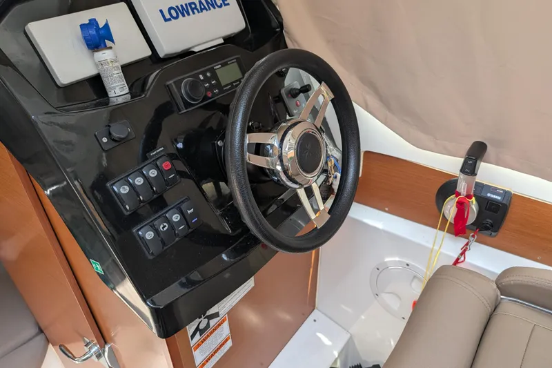 Slide: The Image of Steering console of 2016 Jeanneau Merry Fisher 795 with navigation equipment. - 8