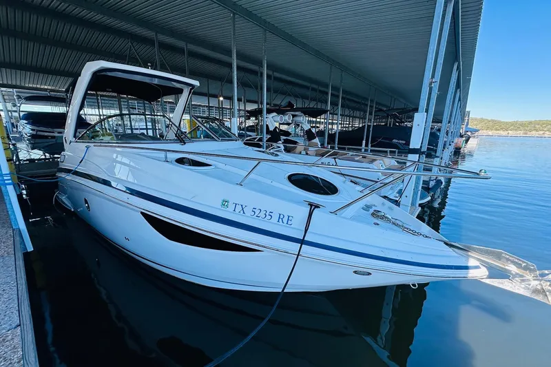 Slide: The Image of 2017 Regal 28 Express boat docked in a marina, side view. - 10