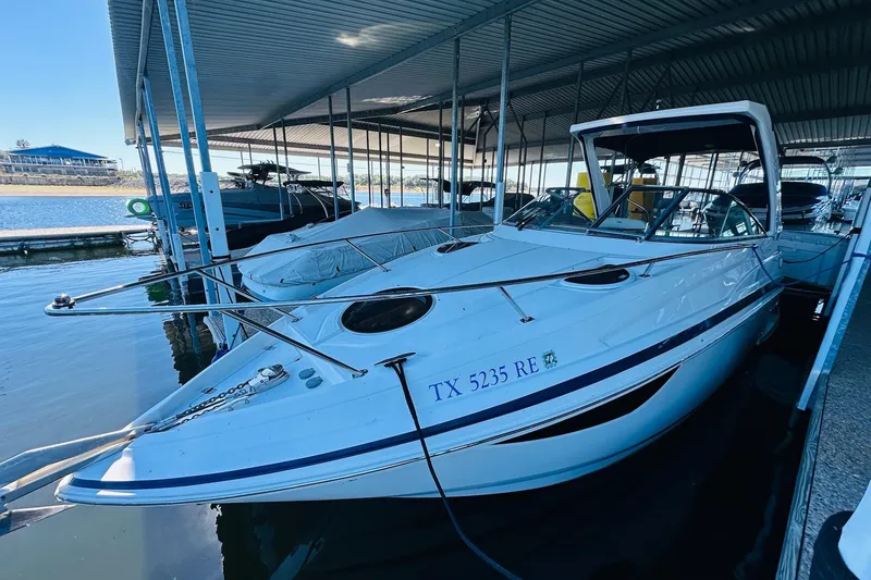 Slide: The Image of 2017 Regal 28 Express boat docked in a covered marina. - 11