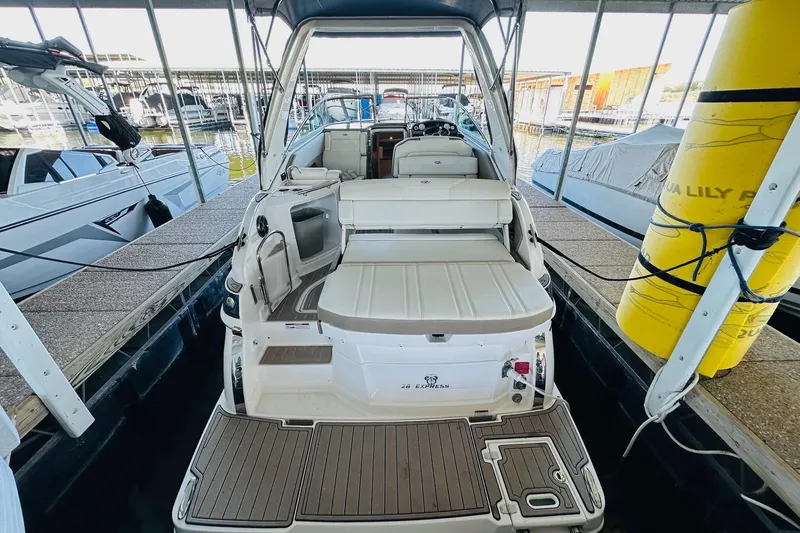 Slide: The Image of 2017 Regal 28 Express boat docked, featuring spacious seating and modern design. - 15