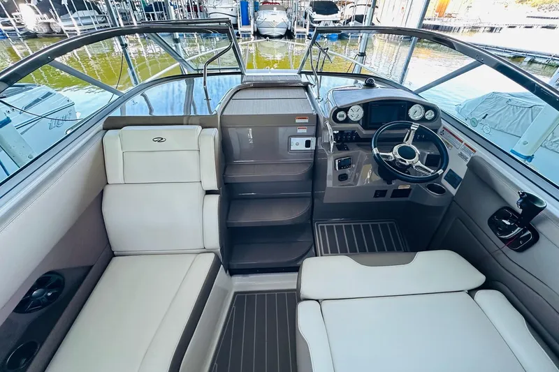 Slide: The Image of 2017 Regal 28 Express boat interior with helm, seating, and modern controls. - 19