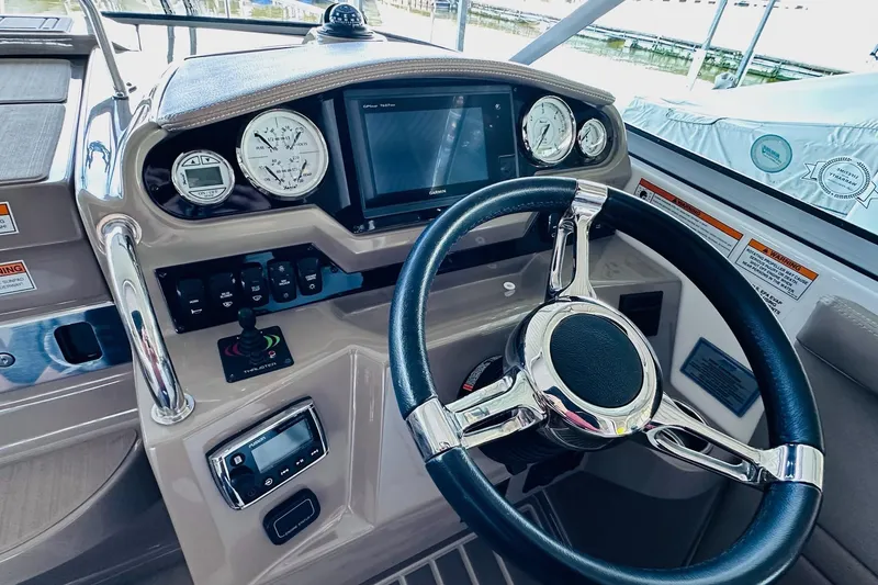 Slide: The Image of 2017 Regal 28 Express boat dashboard with steering wheel and navigation instruments. - 20