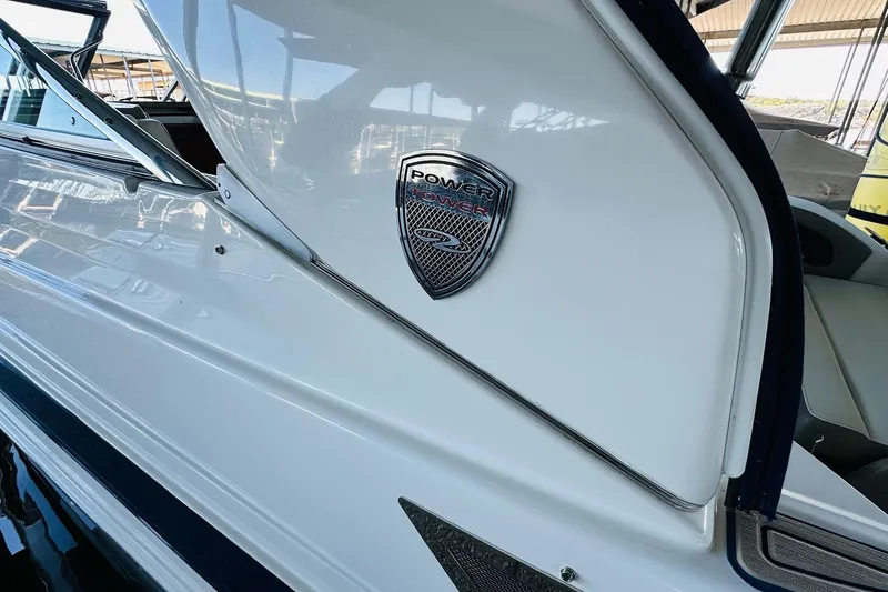 Slide: The Image of 2017 Regal 28 Express boat with Power Tower emblem, docked in a marina. - 22