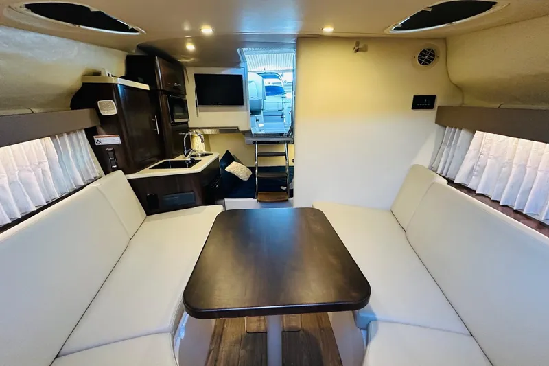 Slide: The Image of Interior of 2017 Regal 28 Express boat with dining area and kitchenette. - 23