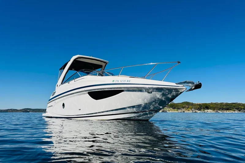 Slide: The Image of 2017 Regal 28 Express boat on calm water under clear blue sky. - 5