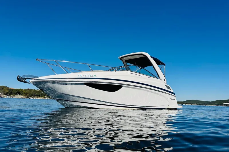 Slide: The Image of 2017 Regal 28 Express boat on calm water under clear blue sky. - 8