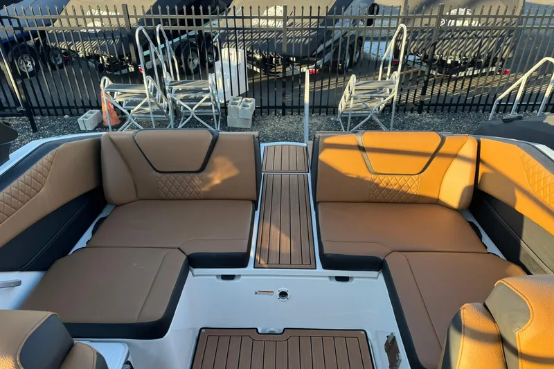 Slide: The Image of 2026 Yamaha Boats 222SD with sleek design and spacious seating, docked under clear skies. - 15