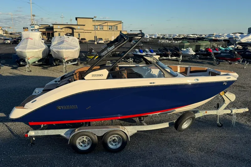 Slide: The Image of Manufacturer Provided Image: 2026 Yamaha Boats 222SD, sleek design, blue hull, red stripe, modern wakeboard tower. - 23