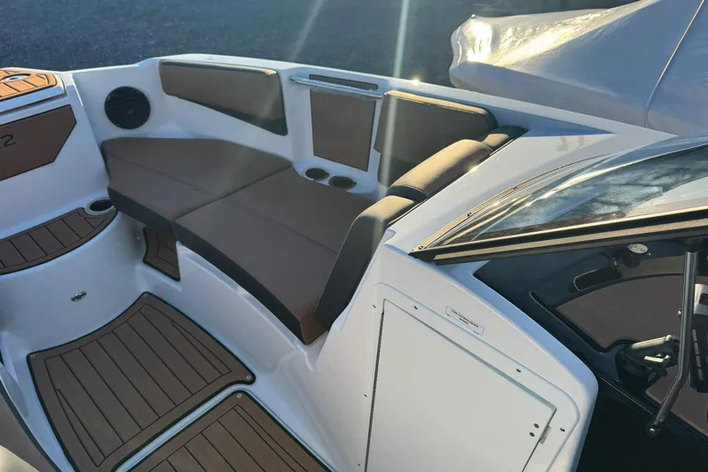 Slide: The Image of 2026 Yamaha Boats 222SD on trailer, blue and white design, parked in marina. - 3