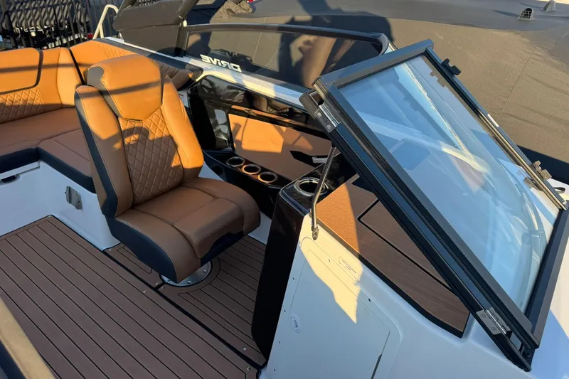 Slide: The Image of 2026 Yamaha Boats 222SD interior with tan seating and wood accents, sunlit view. - 5