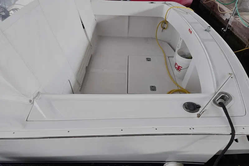 Slide: The Image of 1998 Mainship Pilot 30 boat deck with storage compartments and utility bucket. - 12