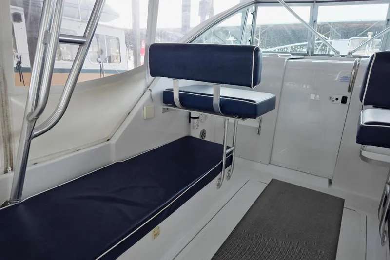 Slide: The Image of 1998 Mainship Pilot 30 interior with blue seating and white accents. - 17
