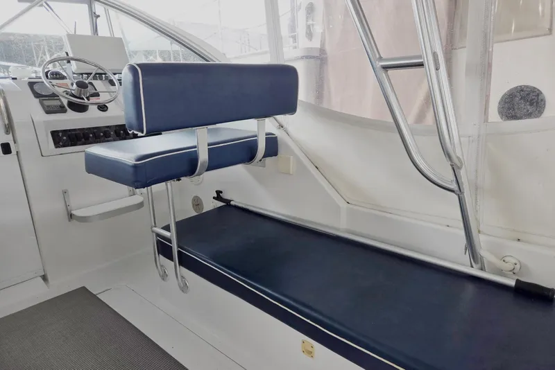 Slide: The Image of 1998 Mainship Pilot 30 interior with blue seating and steering wheel. - 19