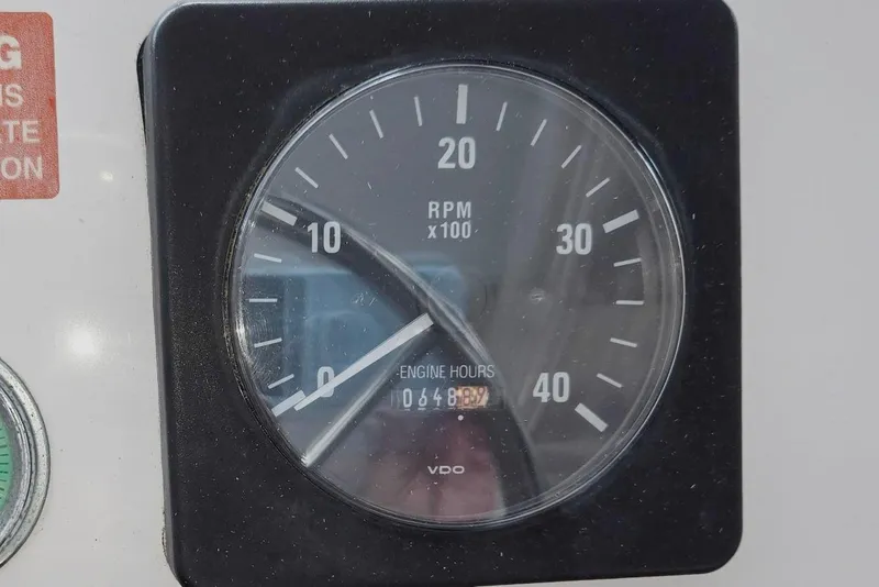 Slide: The Image of RPM gauge of a 1998 Mainship Pilot 30 showing engine hours. - 27