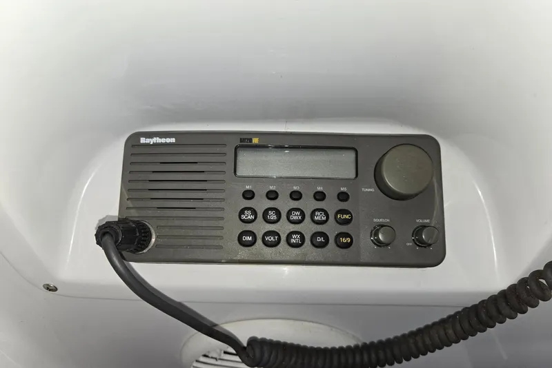 Slide: The Image of Raytheon marine radio on 1998 Mainship Pilot 30 boat dashboard. - 32