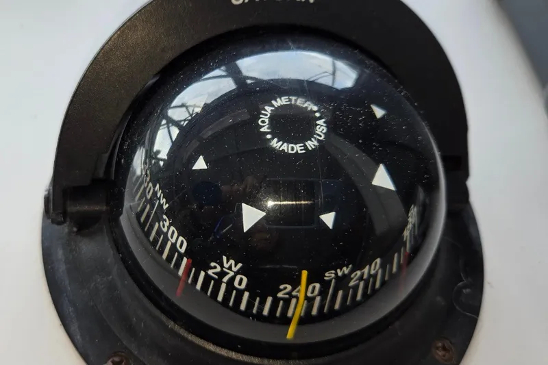 Slide: The Image of Close-up of a compass on a 1998 Mainship Pilot 30 boat. - 34