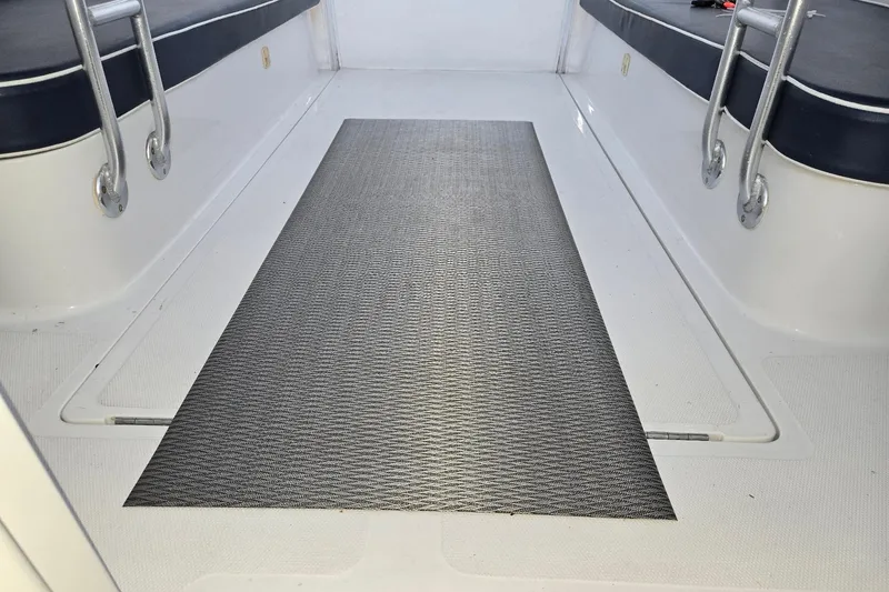 Slide: The Image of Interior of 1998 Mainship Pilot 30 boat with seating and non-slip mat. - 35
