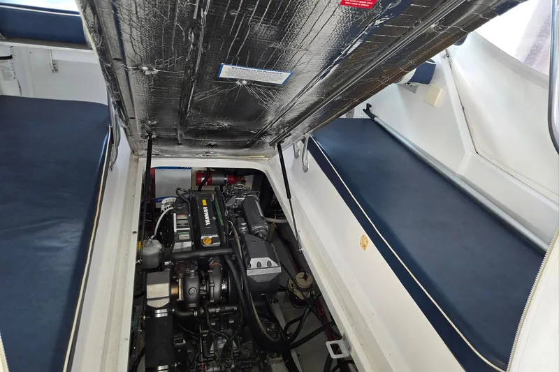 Slide: The Image of 1998 Mainship Pilot 30 engine compartment with open hatch, showcasing engine details. - 36