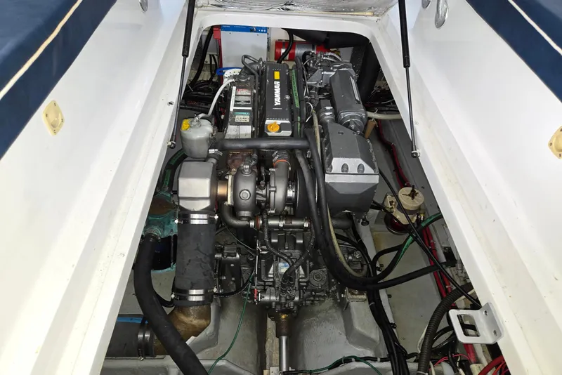 Slide: The Image of Engine compartment of a 1998 Mainship Pilot 30 boat, featuring a Yanmar engine. - 37