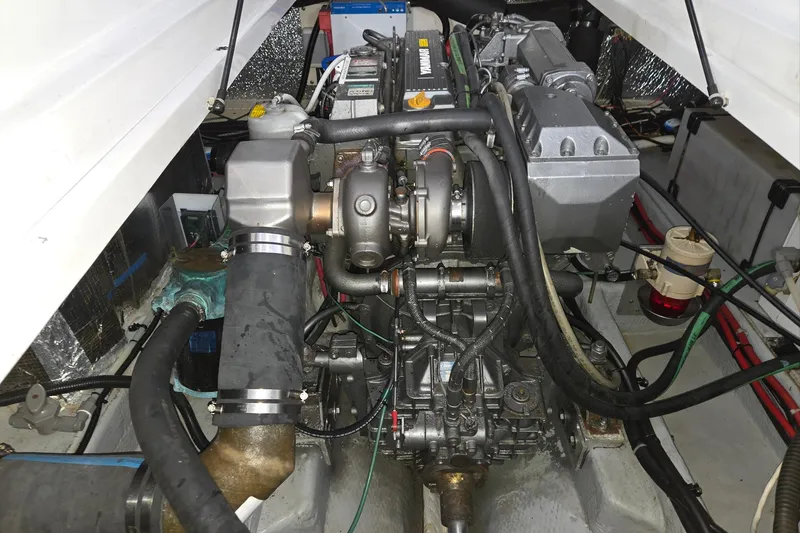 Slide: The Image of Engine compartment of a 1998 Mainship Pilot 30 boat, showcasing mechanical components. - 38