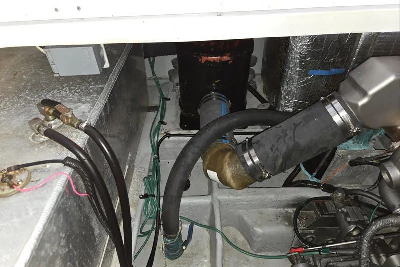 Slide: The Image of Engine compartment of a 1998 Mainship Pilot 30 boat, showing hoses and wiring. - 42