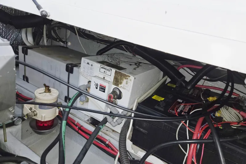 Slide: The Image of 1998 Mainship Pilot 30 engine compartment with batteries and wiring. - 43