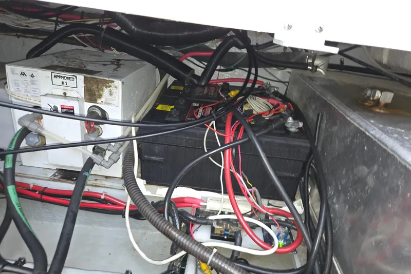 Slide: The Image of 1998 Mainship Pilot 30 engine compartment with wiring and battery setup. - 44