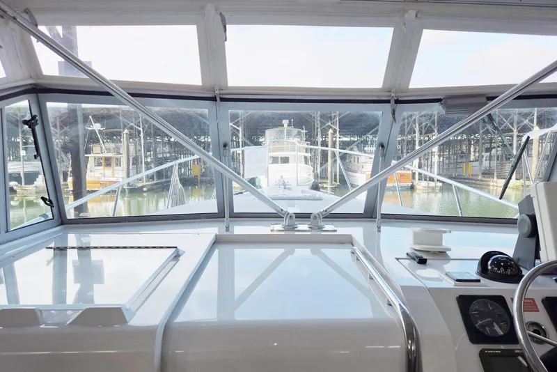 Slide: The Image of 1998 Mainship Pilot 30 boat interior view with marina background. - 47