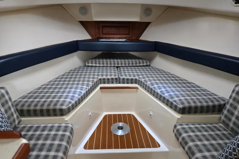 Slide: The Image of 1998 Mainship Pilot 30 cabin interior with plaid cushions and wood accents. - 55
