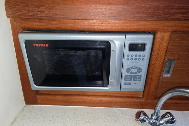 Slide: The Image of Tappan microwave in 1998 Mainship Pilot 30 boat kitchen, wooden cabinetry. - 66