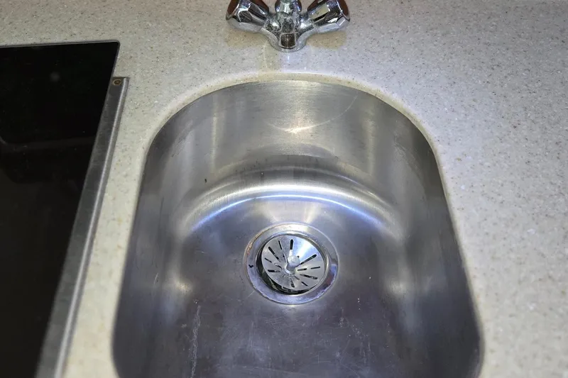 Slide: The Image of Stainless steel sink on 1998 Mainship Pilot 30 boat with beige countertop. - 68