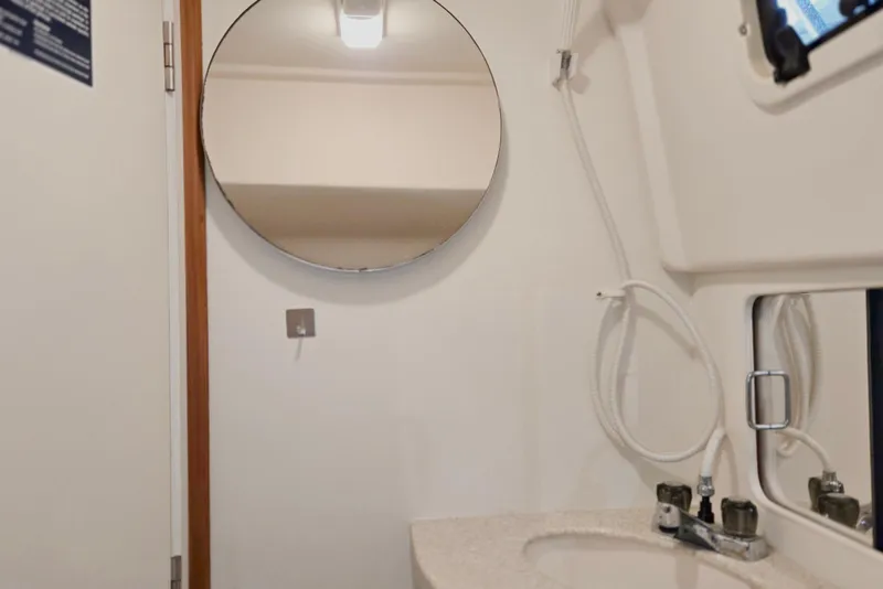 Slide: The Image of Bathroom interior of 1998 Mainship Pilot 30 boat with round mirror and sink. - 71