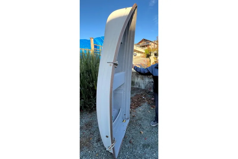 Slide: The Image of 1998 Mainship Pilot 30 boat hull displayed vertically outdoors. - 76