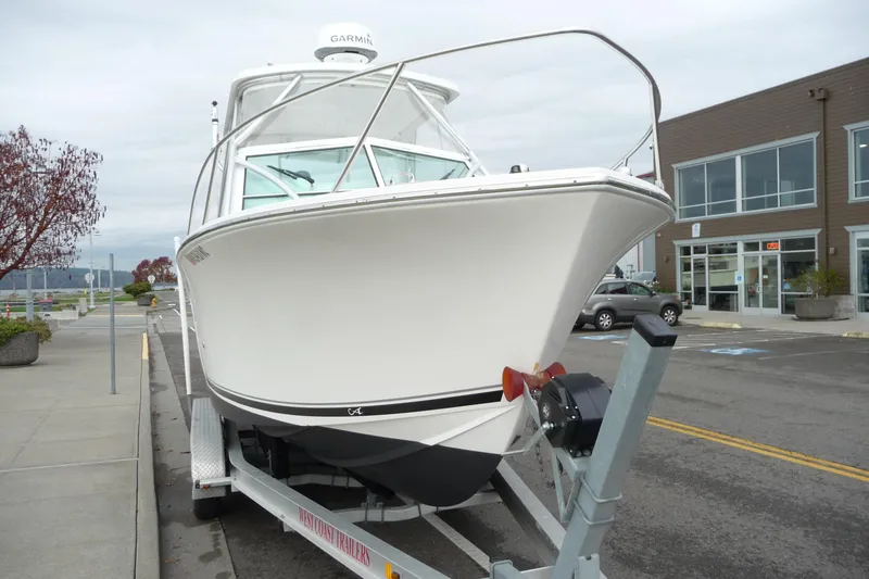 Slide: The Image of 2016 Albemarle 25 Express boat on trailer, parked near a building. - 10